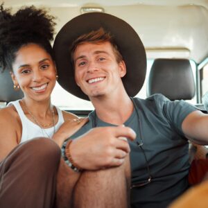 Couple, road trip or bonding in camper travel on safari game drive in nature desert environment or